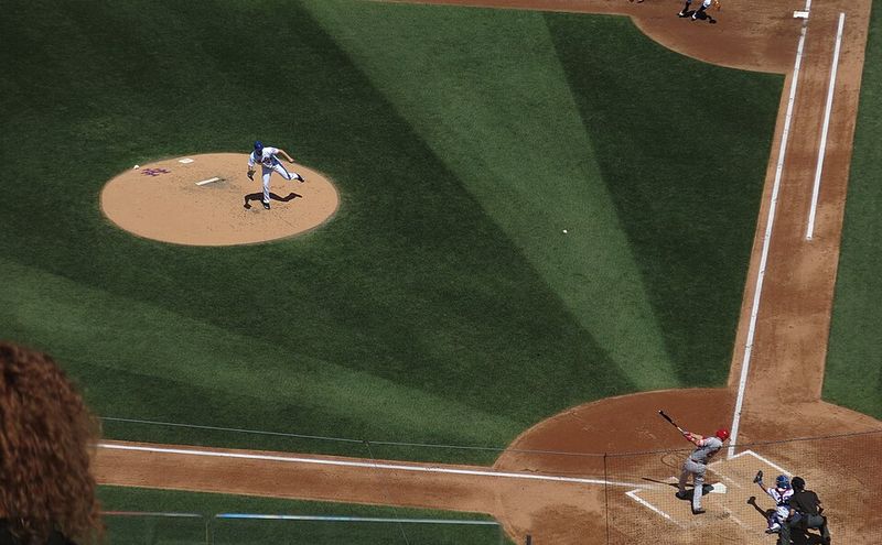 A pitch arrives at home plate on a baseball diamond