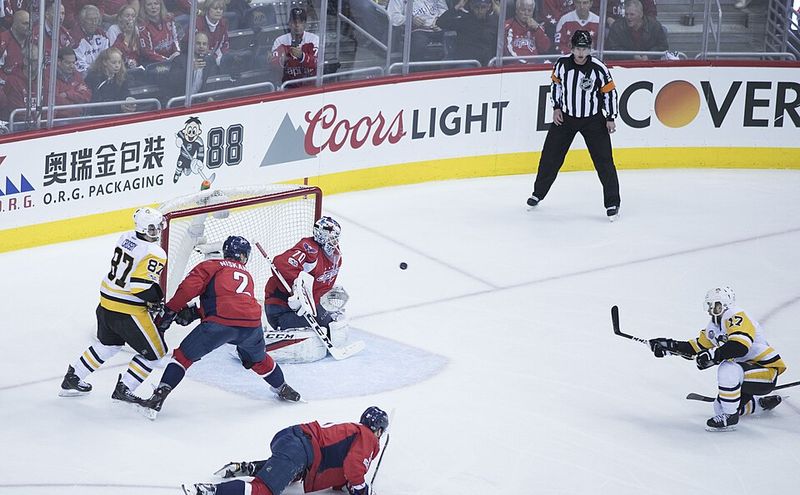 A scramble in front of the hockey net